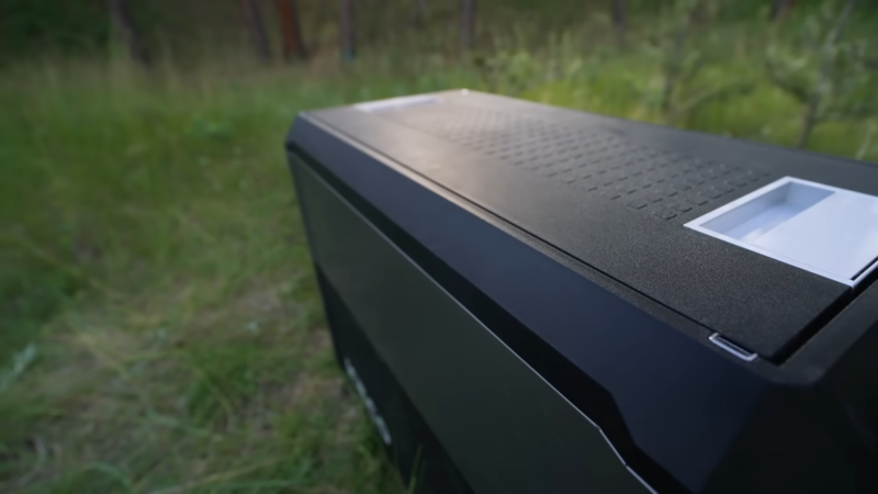 Portable electric car cooler placed outdoors during a camping trip