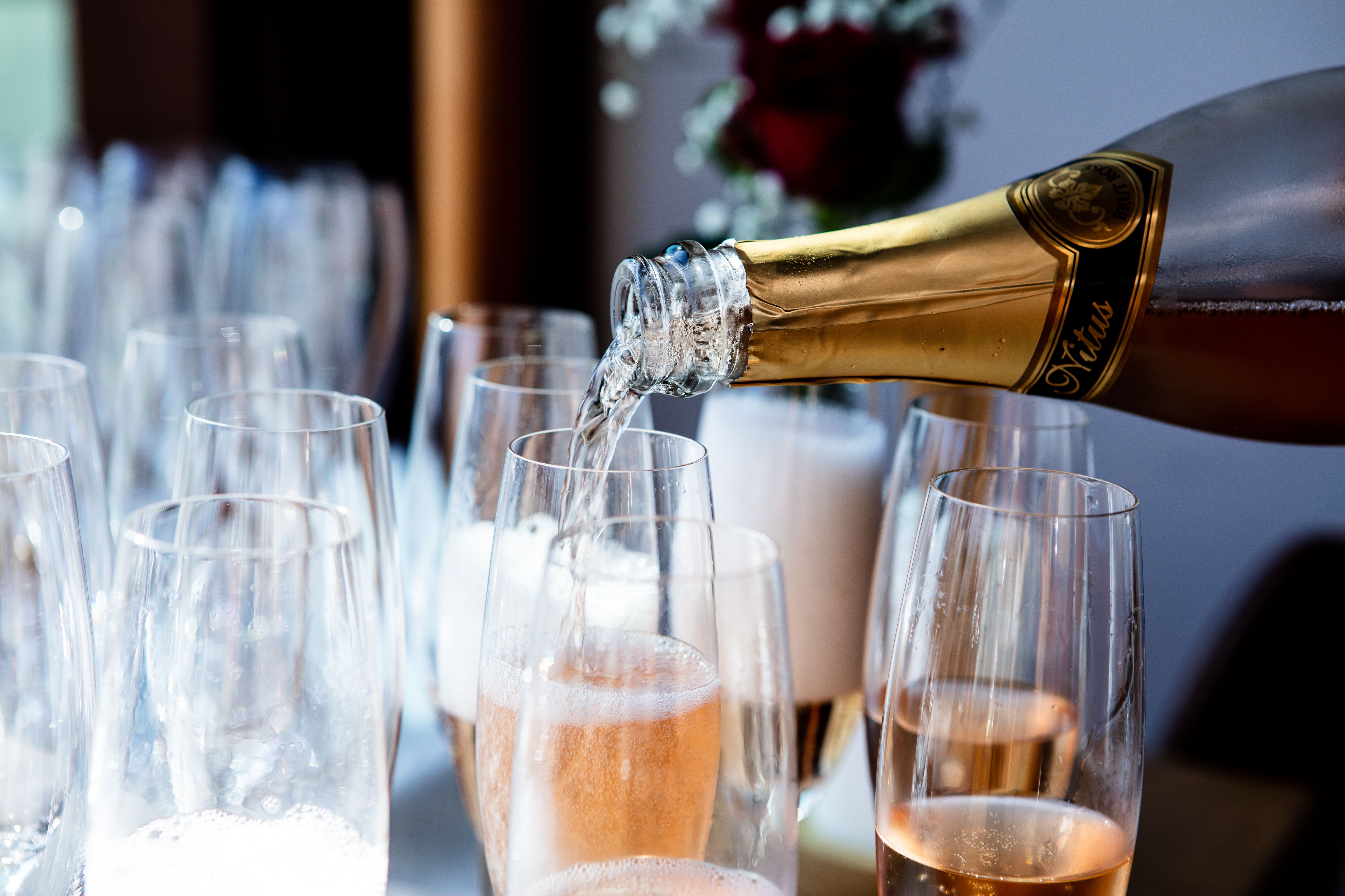 Elegant champagne being poured into flute glasses at a luxury celebration