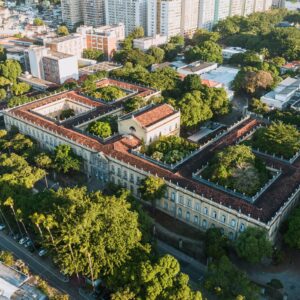 Aerial view of a historic university campus surrounded by lush greenery, illustrating landscape-led campus planning.